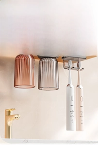Detail showing magnetic upside-down toothbrush holder with grey and pink cups