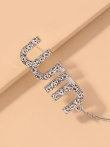Detailed close-up of CUTE letter pendant featuring silver finish and sparkling rhinestones