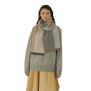Minimalist knit color-block scarf in grey and beige tones for versatile winter styling