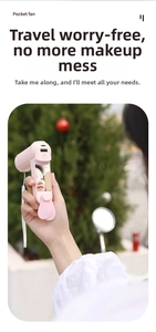 Pink portable foldable hand fan with makeup mirror and USB charging ports shown outdoors