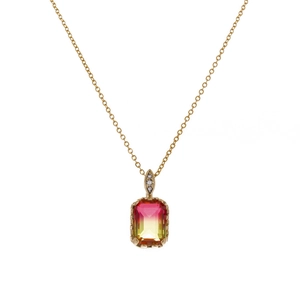 Macro detail of gold necklace featuring a rectangular gradient gemstone and diamond accents