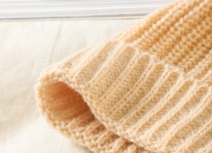 Detailed macro view of the soft ribbed knit texture on the acrylic winter beanie hat