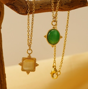Macro detail of retro 18K gold plated necklaces with sunburst stones on a branch
