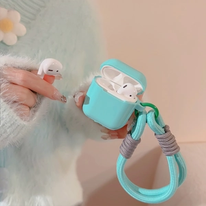 Detail of light blue silicone AirPods case with matching braided lanyard held by hand