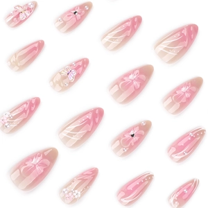 Pink gradient almond press-on nails with 3D floral accents and pearl butterfly charms