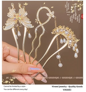 Detail of gold butterfly hair pins with elegant pearl tassels and sparkling crystals