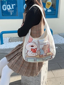 White canvas tote bag with cute cartoon bear print and wide shoulder strap for casual use