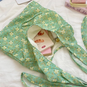 Detail view of the spacious inner compartment of the green floral print tote bag