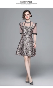 Close-up of floral dress detail featuring delicate lace mesh and elegant pearl accents