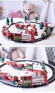 Macro view of Christmas train set with red engine, green carriages and track accessories