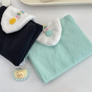 Détail du porte-cartes en tissu doux avec rabat en peluche et pendentif d'ours mignon