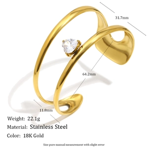 Detailed view of 18K gold plated stainless steel open bangle with heart shaped zircon
