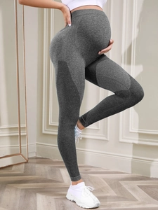 Detail of grey seamless maternity yoga leggings with breathable mesh and tummy support