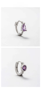 Detailed view of silver titanium steel earrings with purple zircon and braided texture