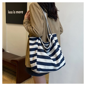 Close-up of black and white striped canvas tote bag with professional lighting details