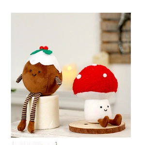 Detail of plush Christmas pudding and red mushroom dolls with soft embroidered texture