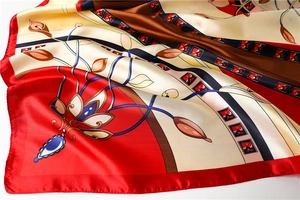 Detailed close-up showing the soft silk texture and floral patterns of the 90cm satin scarf