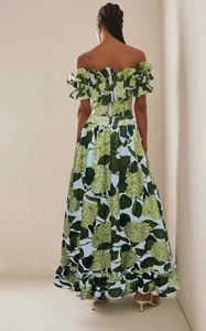 Macro detail of the ruffled off-shoulder neckline with green floral print on summer dress