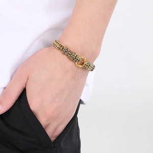 Retro 18K gold plated stainless steel double dragon head bracelet on male wrist