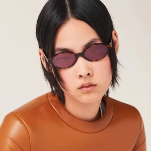 Retro oval tortoiseshell sunglasses with dark purple lenses for a minimalist look