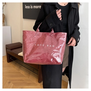Detail of burgundy vintage tote bag with transparent PVC layer and inner texture