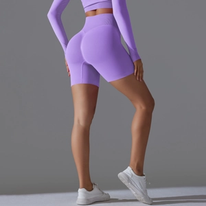 Back view of seamless purple high waist yoga shorts with peach lift contouring