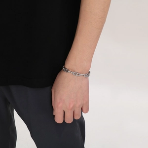 Close-up of minimalist silver geometric chain bracelet worn on wrist for men and women