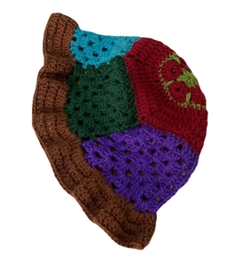 Handmade crochet bucket hat with colorful patchwork knit patterns on white background