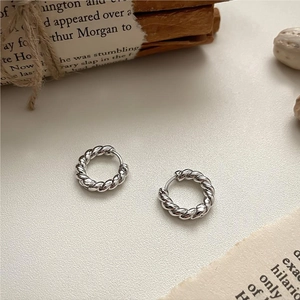 Silver 925 rope twist hoop earrings shown on a vintage background with neutral aesthetic