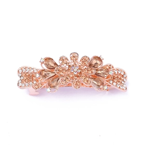 Macro detail of rose gold hair clip with champagne crystals and sparkling rhinestones