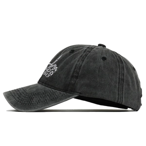 Detailed close-up of skull hand embroidery and GOOD VIBES text on washed cotton cap