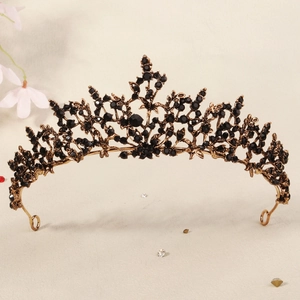 Close-up of vintage black crystal crown with intricate gold alloy base for weddings