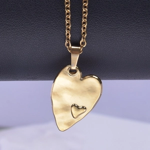 Detail of 18k gold plated heart pendant with unique hammered texture on black leather