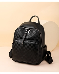 Close-up of black checkerboard textured leather backpack with silver zippers and top handle