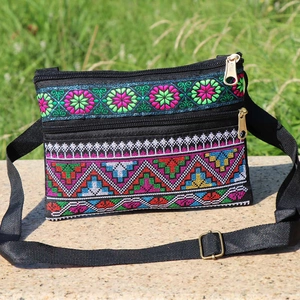 Detailed embroidery patterns on ethnic crossbody bag with multiple zip compartments