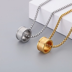 Detail of gold and silver cross pendant necklaces with engraved scriptures and box chain