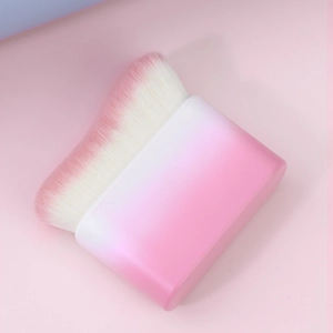 Detail of soft wave-shaped pink gradient makeup brush bristles for seamless foundation application