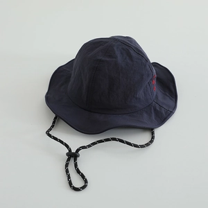 Detail of navy quick-dry sun hat with wide brim, side embroidery and windproof cord