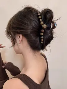 Detail of amber tortoiseshell hair claw clip with side beads on hair