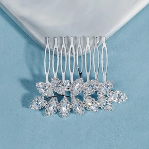 Macro detail of bridal hair comb featuring marquise-cut zircon stones in leaf design