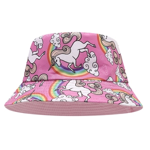 Detail of pink kids bucket hat with unicorn, rainbow and cloud patterns on white background