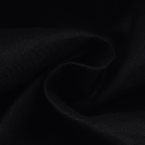 Macro detail of high-quality black twill fabric texture on a retro octagonal baker boy cap