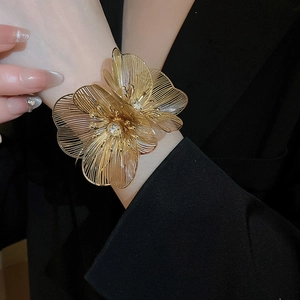 Macro view of gold镂空 floral bracelet with sparkling crystal accents and wire petals