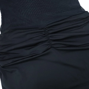 Close-up of black mesh patchwork and ruched elastic fabric on a sexy bodycon dress