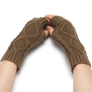 Detail of brown knitted fingerless glove showing thick yarn and diamond texture