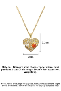 Detail of gold titanium steel necklace with heart pendant and orange zircon inlay