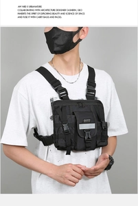 Close-up of black tactical chest rig bag with adjustable straps and reflective stripes
