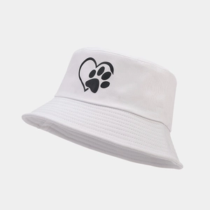 Close-up of white cotton bucket hat featuring a black heart and paw print graphic design