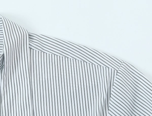 Close-up of fine striped poplin shirt showing detailed shoulder stitching and fabric texture
