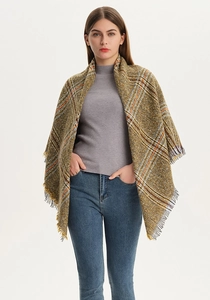 Close-up of yellow and brown plaid triangle shawl with decorative fringe detail